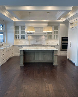 Modern kitchen showcasing services with white cabinetry and a large island